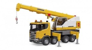 Scania Super 560R ciężarówka żółta z dźwigiem